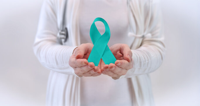 Doctors Hands Presenting Teal Awareness Ribbon - Cervical Cancer, Ovarian Cancer, PTSD, OCD, Anxiety