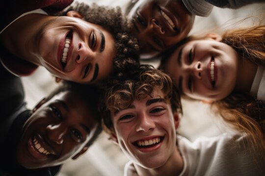 Happy diverse teenagers looking down at camera in a circle. Perfect for youth, friendship, team spirit, community, education, or lifestyle concepts. Ideal for banners and social campaigns.