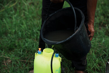 Water collection efforts rural area human activity green environment close-up view resource management