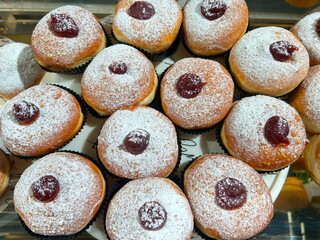 Sufganiyah - Hanukkah doughnuts on display at a coffee shop. Sufganiyot. Israeli holiday doughnuts.