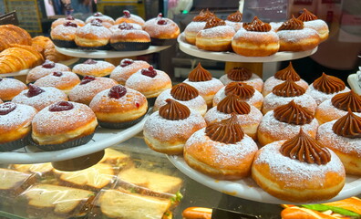 Sufganiyah - Hanukkah doughnuts on display at a coffee shop. Sufganiyot. Israeli holiday doughnuts.