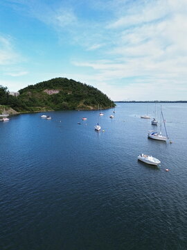 Aerial view of boats dotting a tranquil lake under a bright sky near a verdant hill, creating a serene and picturesque scene, Kalu&Aring;&frac34;a, Ko&Aring;&iexcl;ick&Atilde;&frac12; kraj, Slovakia.