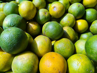 Close up shot of pile of fresh sweet lemon.