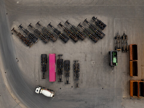 Aerial view of several vehicles with different colors parked systematically on a concrete ground, Berlin, Germany.