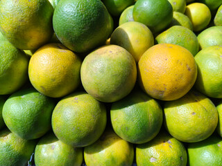 Close up shot of pile of fresh sweet lemon.