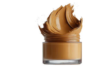 Beige foundation overflowing from a clear glass jar against a black backdrop for beauty and makeup themes on transparent background