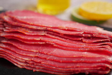 Delicious thinly sliced meat arranged on a platter