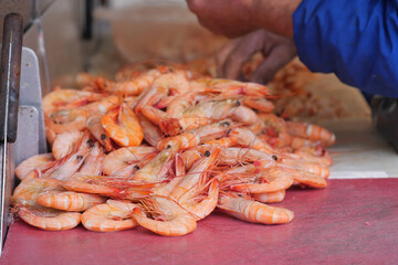 Fresh shrimp preparation at seafood market in early morning