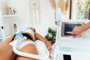 Body contouring and sculpting. Hardware cosmetology. Ultrasound cavitation body contouring treatment, anti-cellulite and anti-fat therapy in beauty salon. Modern beauty treatments concept.