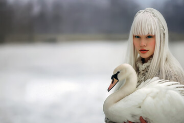 Ethereal December  portrait: White-haired girl with swan in field