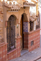narrow street with house facade and design on brick wall in the house