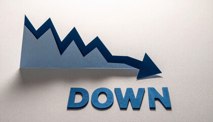 青い切紙で作られたグラフが鋭く下降しdownの文字に突き刺さる象徴的構図