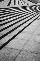 Modern Concrete Staircase with Metal Railings and Geometric Shadows