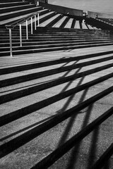 Modern Concrete Staircase with Metal Railings and Geometric Shadows