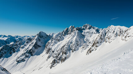 Fototapeta premium Snow-Covered Mountain Landscape Under Blue Sky