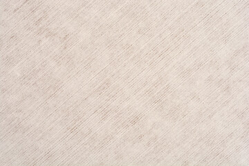 A full-frame close-up of a light beige or off-white fabric with a distinct diagonal woven texture, creating a subtle, clean textile background
