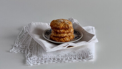 Homemade sugar-crusted cookies sit on a blue-patterned plate with folded linen napkins underneath.