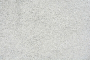 A full-frame, uniform close-up of a light gray suede or nubuck leather texture with a soft, slightly rough nap