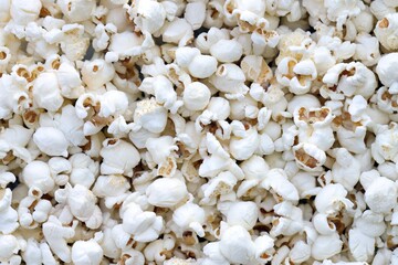 Flatlay of salted popcorn with cheese. Heap of homemade delicious popcorn on a rustic wooden table