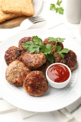 Delicious patties with parsley and ketchup on white wooden table, closeup