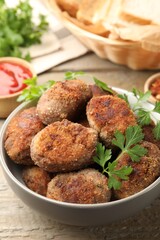 Tasty meat patties served on wooden table, closeup