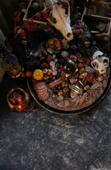 wiccan altar with wheel of the year on dark table. animal skull, witch cauldron, amulets, crystalsб magic things. witchcraft, esoteric ritual for Samhain holiday. autumn season. top view. copy space