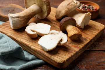 Fresh porcini mushrooms on wooden table, closeup