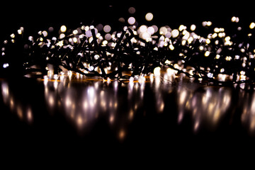 Abstract bokeh lights on a dark background. Christmas magical light, overlay or lens flare effect