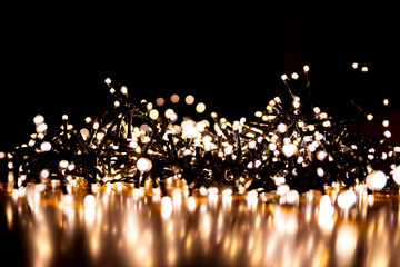 Abstract bokeh lights on a dark background. Christmas magical light, overlay or lens flare effect