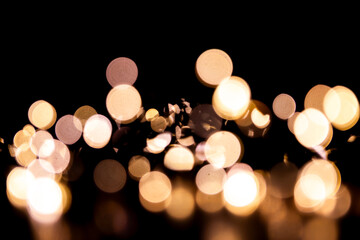 Abstract bokeh lights on a dark background. Christmas magical light, overlay or lens flare effect