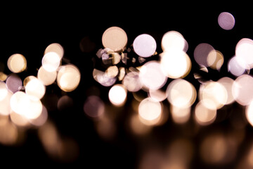 Abstract bokeh lights on a dark background. Christmas magical light, overlay or lens flare effect