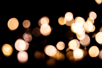 Abstract bokeh lights on a dark background. Christmas magical light, overlay or lens flare effect