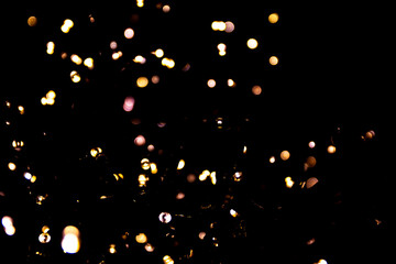 Abstract bokeh lights on a dark background. Christmas magical light, overlay or lens flare effect