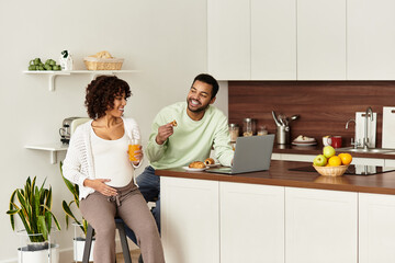 Joyful couple sharing a moment at home while awaiting their new baby