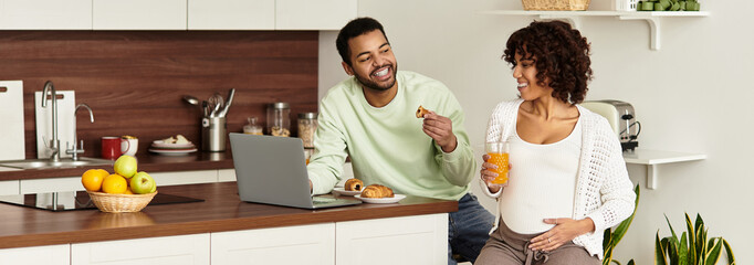 Joy and laughter fill a cozy kitchen as a couple plans for their new arrival