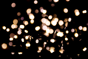 Abstract bokeh lights on a dark background. Christmas magical light, overlay or lens flare effect