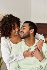 Happy couple enjoying each other's company in a modern apartment
