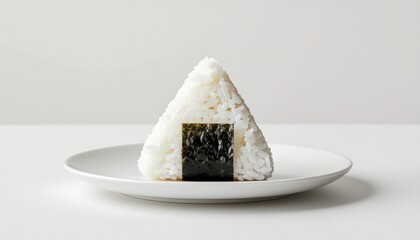 Triangle-shaped Japanese Onigiri Rice Ball on a White Plate A Culinary Delight