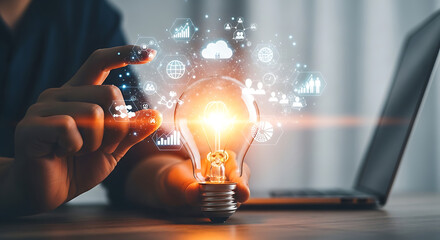 Man holding light bulb with business icons, concept of idea and innovation
