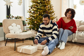 Joyful African American couple sharing love and laughter during Christmas celebration