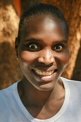 portrait single young african woman with surprised demeanor expression , braids, dreadlocks hairstyle, head and shoulders
