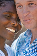 portrait , interracial couple, young african woman and white man, head and shoulders