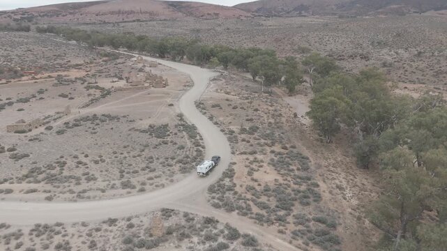 Dual cab ute towing caravan arriving at Kanyaka Ruins, South Australia, 
