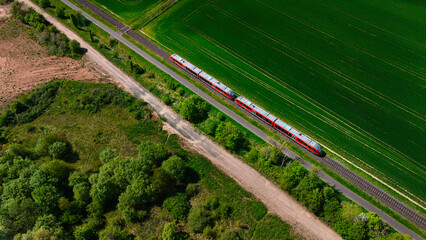 Aerial View of Red Train in Lush Green Fields