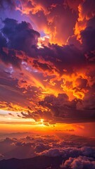 Fototapeta premium Aerial View of a Spectacular Burning Sunset Sky Above the Clouds.
