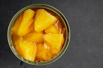 Pineapple canned chunks sweet fruit dessert tasty snack fresh delicious gourmet food background on the table rustic top view copy space keto and paleo diet vegetarian and vegan food