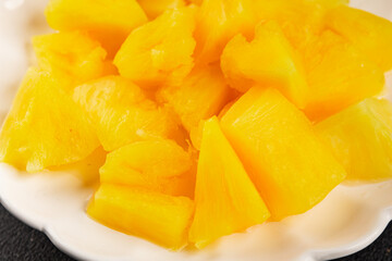 Pineapple canned chunks sweet fruit dessert tasty snack fresh delicious gourmet food background on the table rustic top view copy space keto and paleo diet vegetarian and vegan food