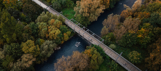 Aerial View of Wooden Bridge Over Autumn River