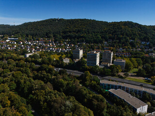 Aerial View of Suburban Area with Forest and Hills
