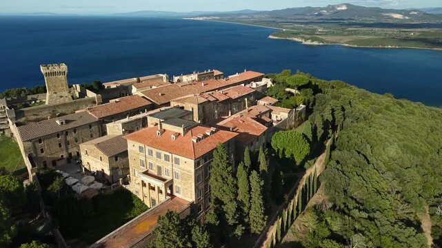 Italy, landmarks of Tuscany. Populonia ancient etruscan city and fortiefied village overlooking the sea. Livorno province. high angle 4k aerial drone footage